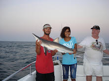 couple holding large fish on aquaman fishing charter